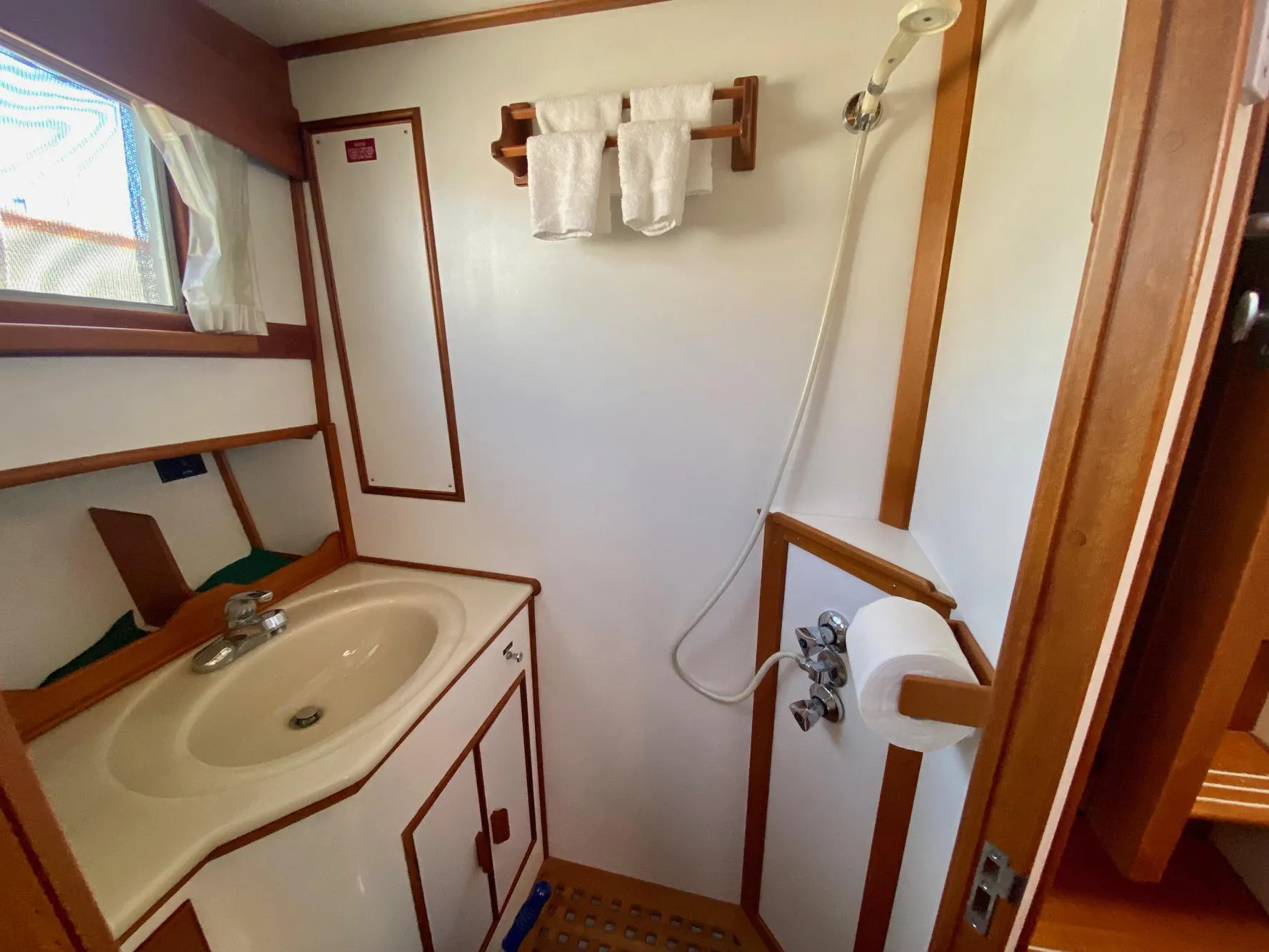 Bathroom interior of 1997 Grand Banks Classic yacht, featuring sink and shower.