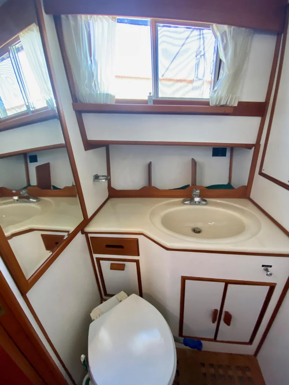 1997 Grand Banks Classic yacht bathroom with sink, mirror, and toilet.