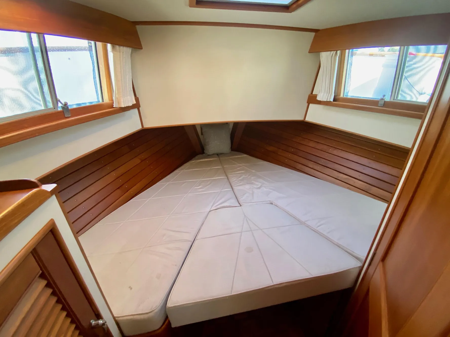 1997 Grand Banks Classic boat cabin with wooden interior and cushioned bed.