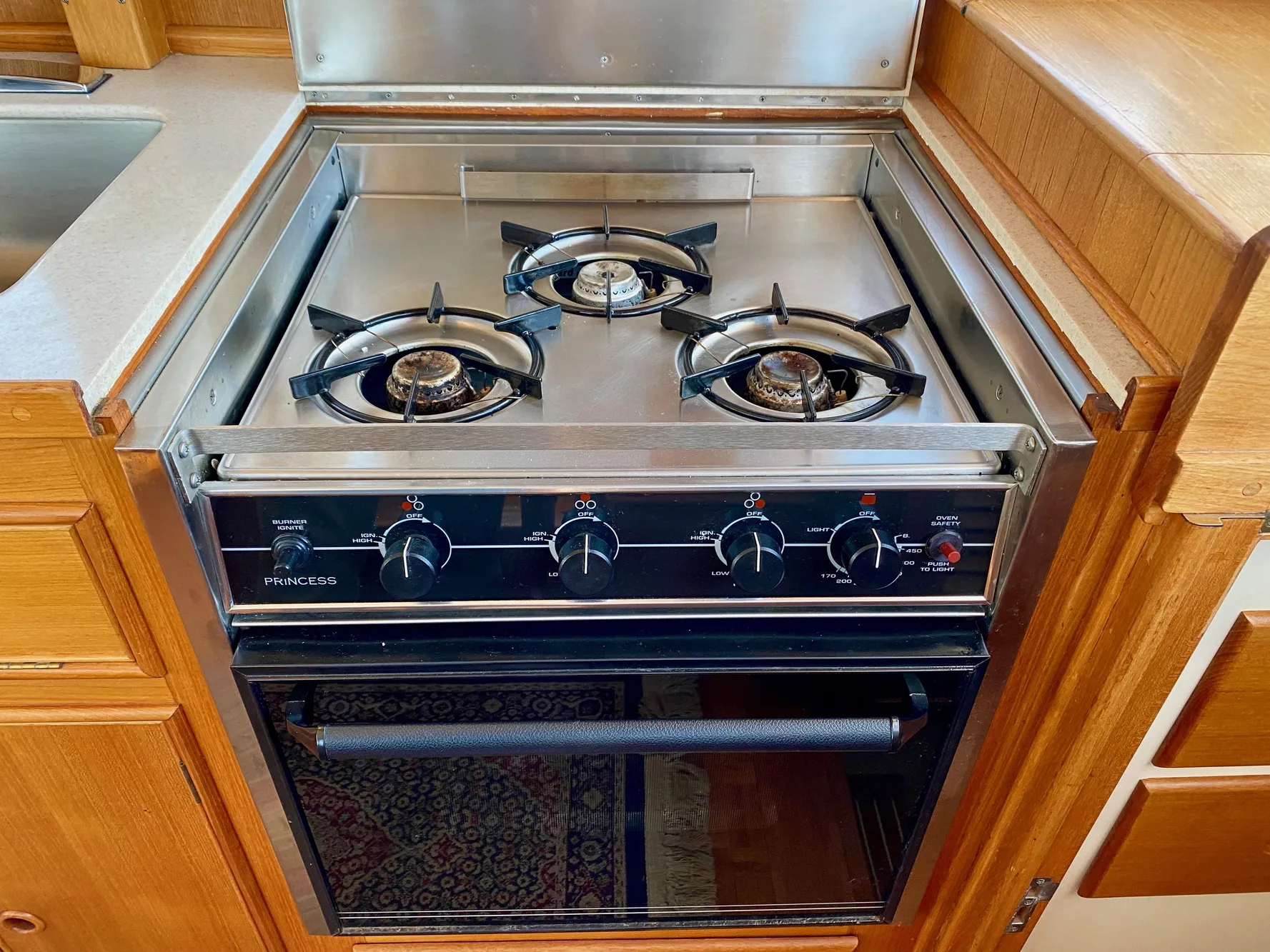Three-burner stove and oven in 1997 Grand Banks Classic yacht kitchen.