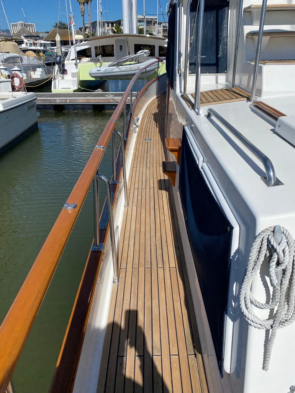 1997 Grand Banks Classic yacht with teak deck and marina view.
