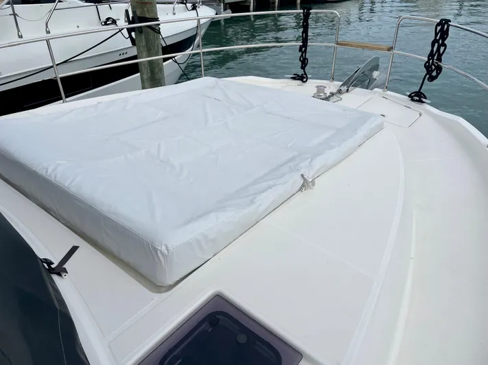  Yacht Photos Pics 2026 Beneteau Swift Trawler 41 deck with cushioned sunbathing area.