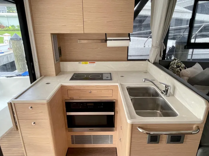  Yacht Photos Pics Modern kitchen in 2026 Beneteau Swift Trawler 41 with stove, sink, and oven.