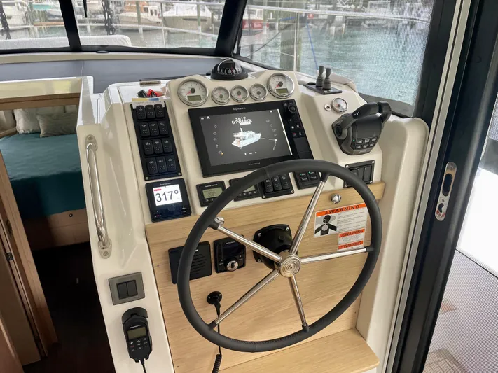  Yacht Photos Pics 2026 Beneteau Swift Trawler 41 helm with modern navigation controls and steering wheel.