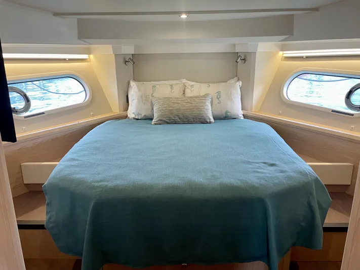  Yacht Photos Pics 2026 Beneteau Swift Trawler 41 cabin with cozy bed and ocean view windows.