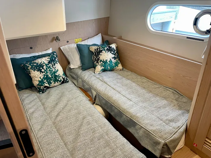  Yacht Photos Pics 2026 Beneteau Swift Trawler 41 cabin with twin beds and decorative pillows.