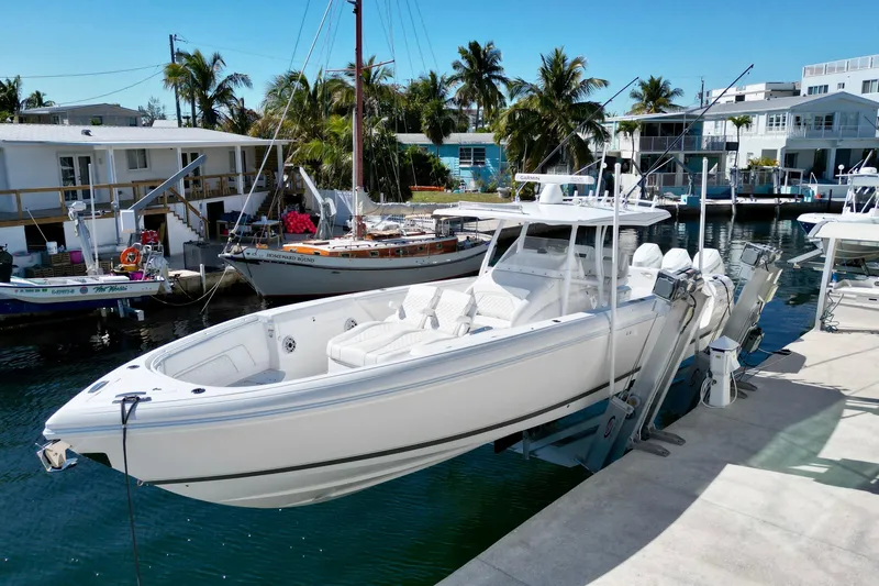  Yacht Photos Pics 2024 Intrepid 407 Nomad FE boat docked in a sunny marina setting.