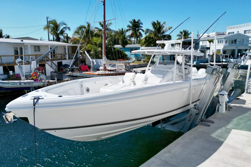  Yacht Photos Pics 2024 Intrepid 407 Nomad FE boat docked in a sunny marina setting.