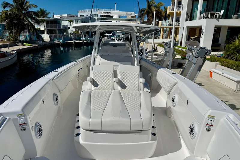  Yacht Photos Pics 2024 Intrepid 407 Nomad FE boat with luxurious seating and modern design in a marina setting.