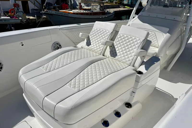 Yacht Photos Pics Luxurious seating on 2024 Intrepid 407 Nomad FE boat with quilted white upholstery.