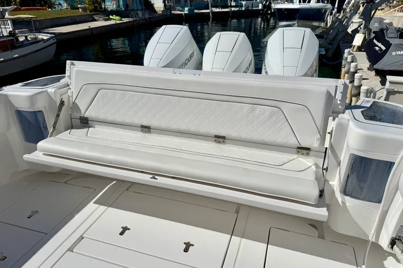  Yacht Photos Pics 2024 Intrepid 407 Nomad FE boat with luxurious seating and powerful engines docked.