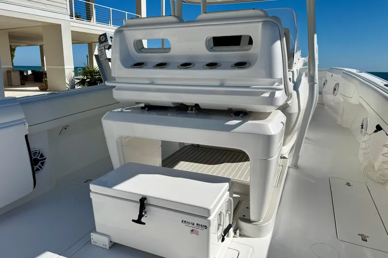  Yacht Photos Pics 2024 Intrepid 407 Nomad FE boat interior with seating and storage, ocean view in background.