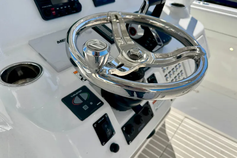  Yacht Photos Pics Steering wheel of 2024 Intrepid 407 Nomad FE boat, featuring modern controls and dashboard.