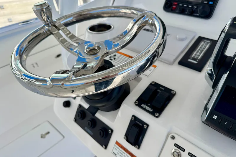  Yacht Photos Pics 2024 Intrepid 407 Nomad FE boat helm with polished steering wheel and controls.