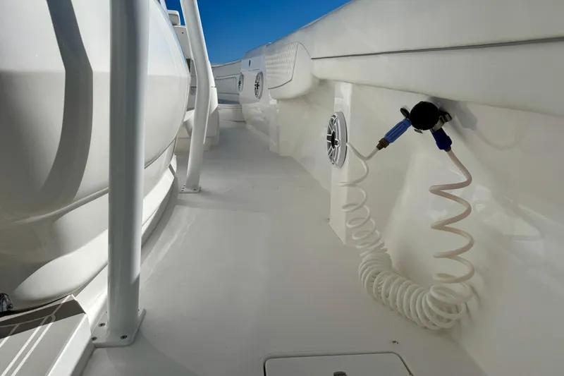  Yacht Photos Pics 2024 Intrepid 407 Nomad FE boat deck with coiled hose and speaker.