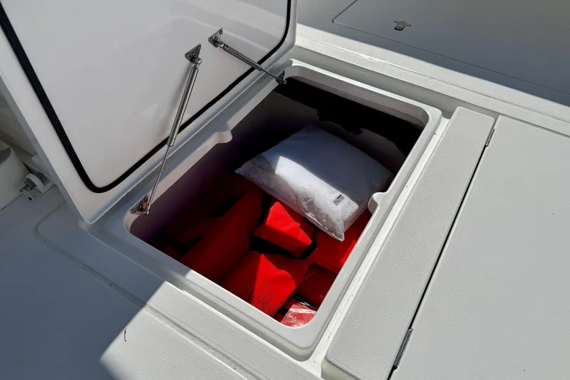 Yacht Photos Pics Open storage compartment on 2024 Intrepid 407 Nomad FE boat with life jackets inside.