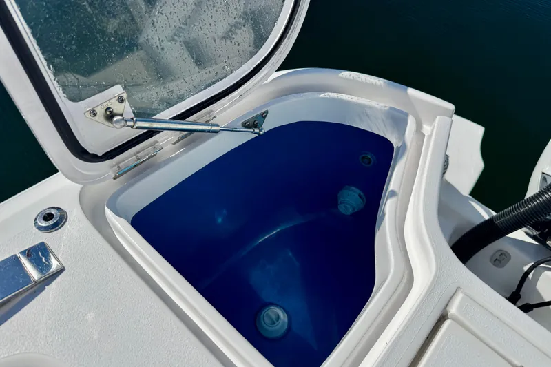  Yacht Photos Pics Open storage compartment on 2024 Intrepid 407 Nomad FE boat, featuring blue interior.