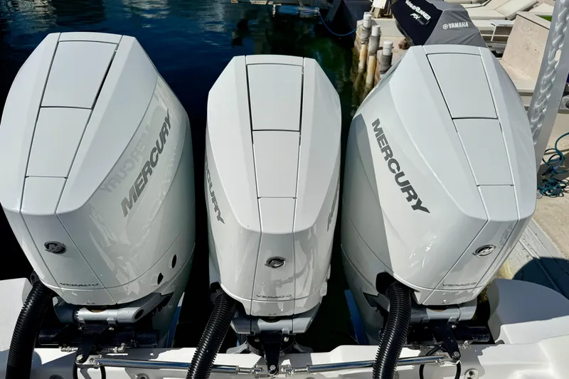  Yacht Photos Pics Triple Mercury outboard engines on a 2024 Intrepid 407 Nomad FE boat at a dock.