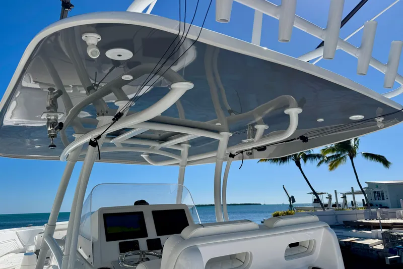  Yacht Photos Pics 2024 Intrepid 407 Nomad FE boat console with ocean view and palm trees.
