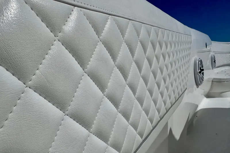  Yacht Photos Pics 2024 Intrepid 407 Nomad FE boat interior with diamond-stitched upholstery and speakers.