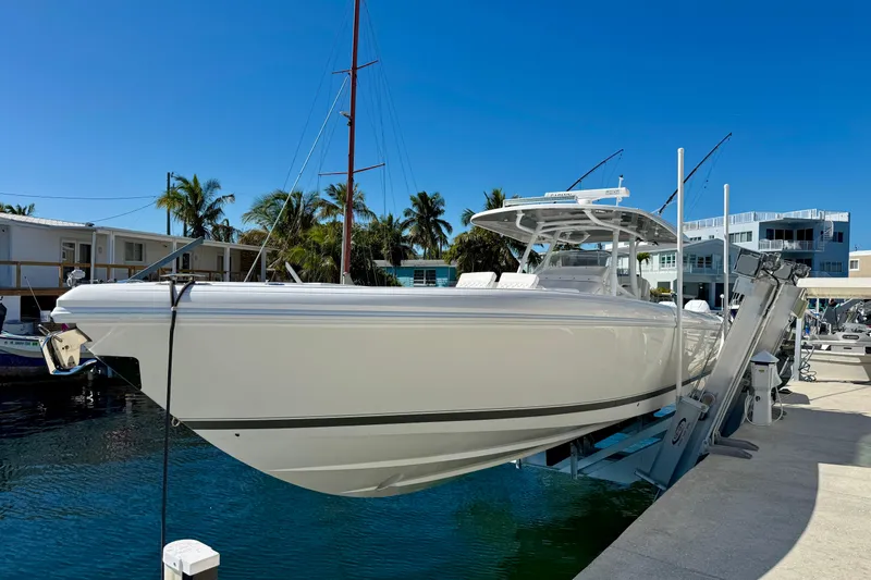  Yacht Photos Pics 2024 Intrepid 407 Nomad FE boat docked at marina under clear blue sky.