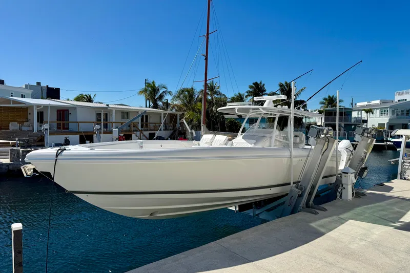  Yacht Photos Pics 2024 Intrepid 407 Nomad FE boat docked in a sunny marina setting.