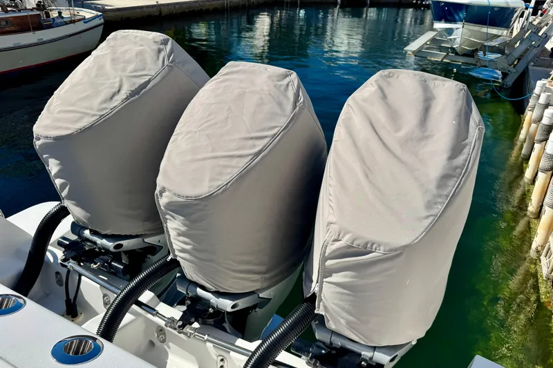  Yacht Photos Pics 2024 Intrepid 407 Nomad FE with covered outboard motors at a marina.