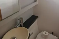 Bathroom interior of 2018 Nautitech 40 Open catamaran with sink and toilet.