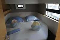 Cozy cabin interior of 2018 Nautitech 40 Open catamaran with neatly arranged bedding.
