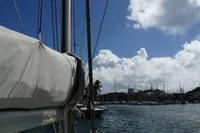 Nautitech 40 Open 2018 catamaran sailing in a sunny marina with blue skies.