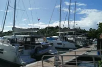 2018 Nautitech 40 Open catamarans docked at a marina under a clear blue sky.