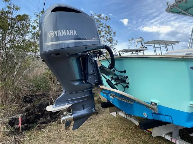Drift Wood Yacht Photos Pics 2017 Custom Carolina 28 CC boat with Yamaha outboard motor, parked on grass.