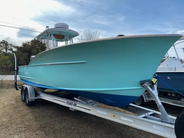 Drift Wood Yacht Photos Pics 2017 Custom Carolina 28 CC Harrison Boatworks on trailer, light blue hull, outdoor setting.