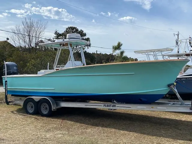 Drift Wood Yacht Photos Pics 2017 Custom Carolina 28 CC Harrison Boatworks on trailer, light blue hull, outdoor setting.