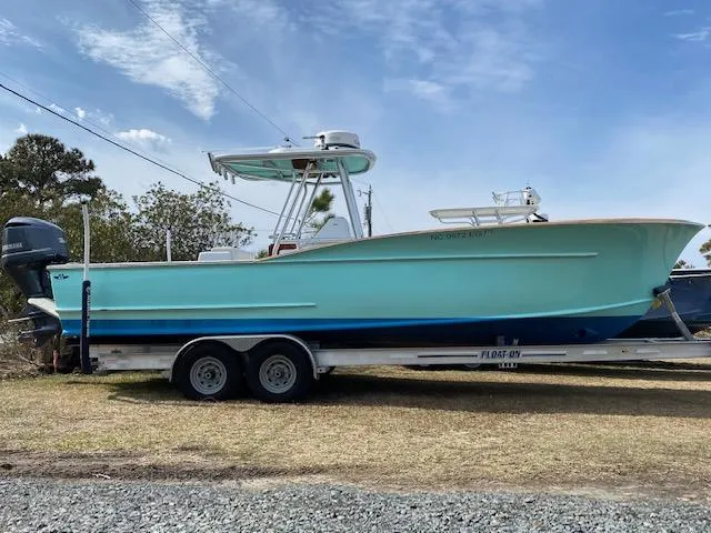 Drift Wood Yacht Photos Pics 2017 Custom Carolina 28 CC Harrison Boatworks on trailer, light blue hull, parked outdoors.