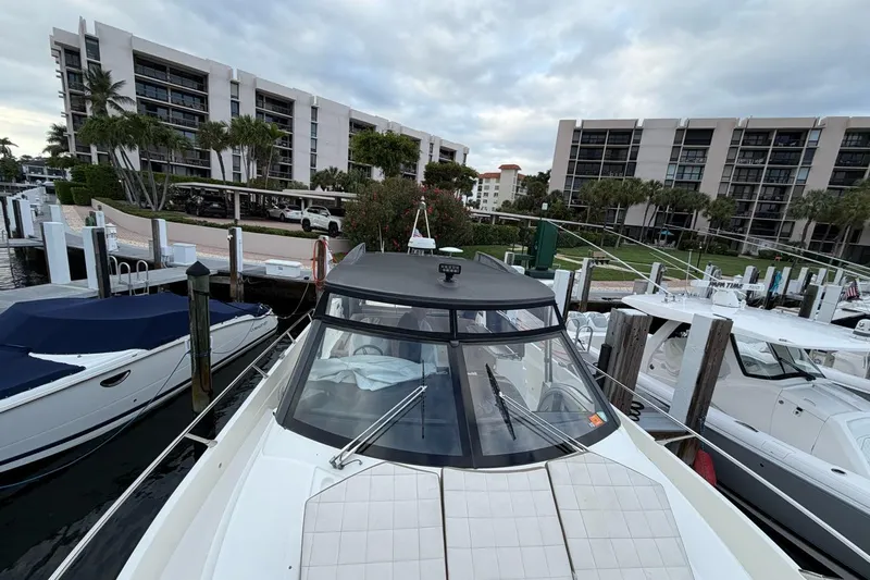  Yacht Photos Pics 2019 Absolute 40 SLT yacht docked at marina with modern buildings in background.