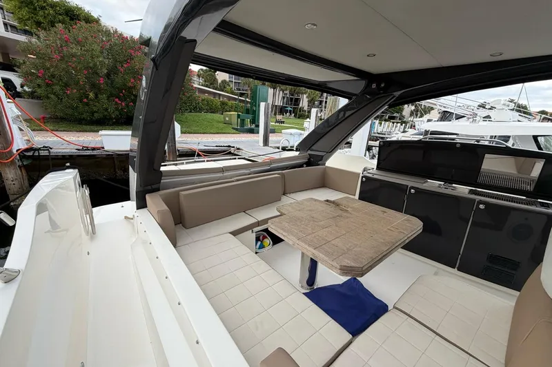  Yacht Photos Pics 2019 Absolute 40 SLT yacht interior with seating and table, docked at marina.