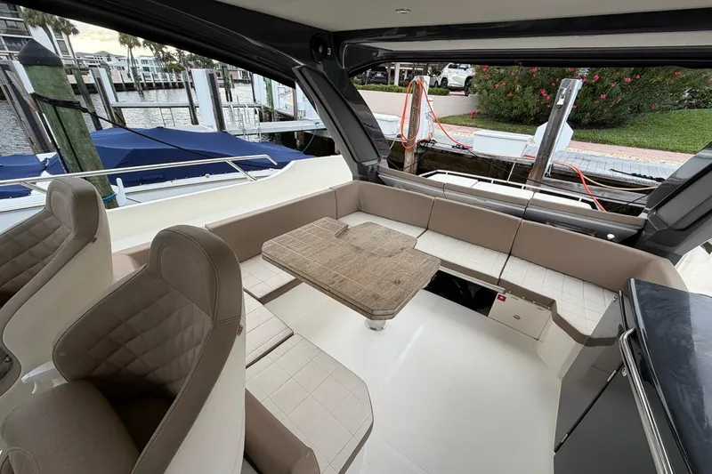  Yacht Photos Pics Luxurious 2019 Absolute 40 SLT yacht interior with elegant seating and wooden table.