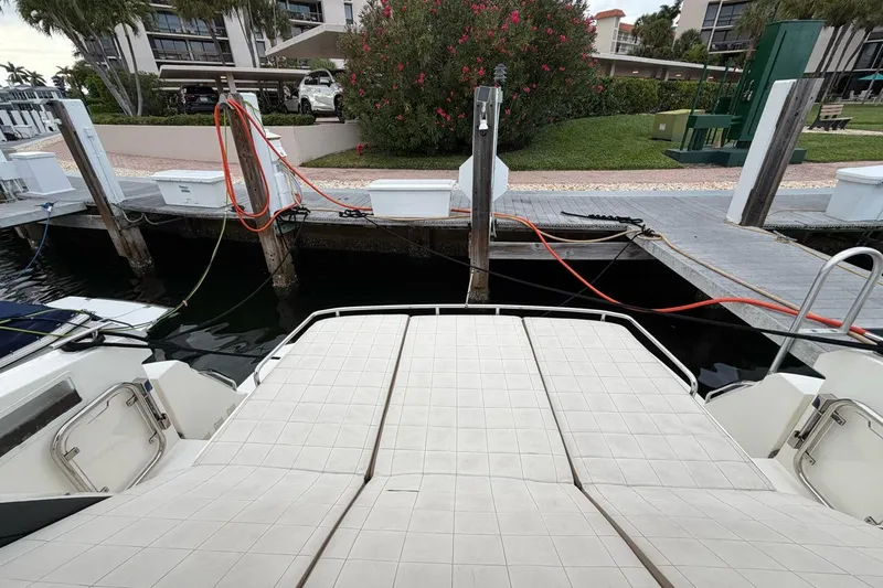  Yacht Photos Pics 2019 Absolute 40 SLT yacht docked at marina with lush greenery.