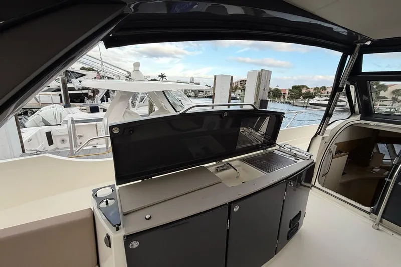  Yacht Photos Pics Outdoor kitchen on a 2019 Absolute 40 SLT yacht, docked at a marina.