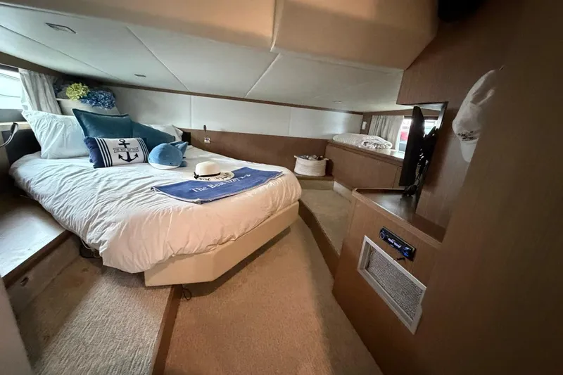  Yacht Photos Pics Luxurious cabin interior of 2019 Absolute 40 SLT yacht with cozy bed and modern amenities.