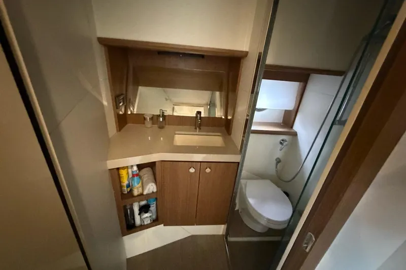  Yacht Photos Pics Luxurious bathroom in 2019 Absolute 40 SLT yacht, featuring modern fixtures and wooden cabinetry.