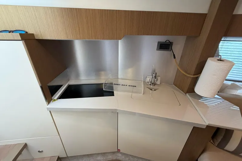  Yacht Photos Pics Modern kitchen area in a 2019 Absolute 40 SLT yacht with sleek countertops.