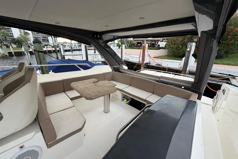  Yacht Photos Pics 2019 Absolute 40 SLT yacht interior with seating and table, docked at marina.