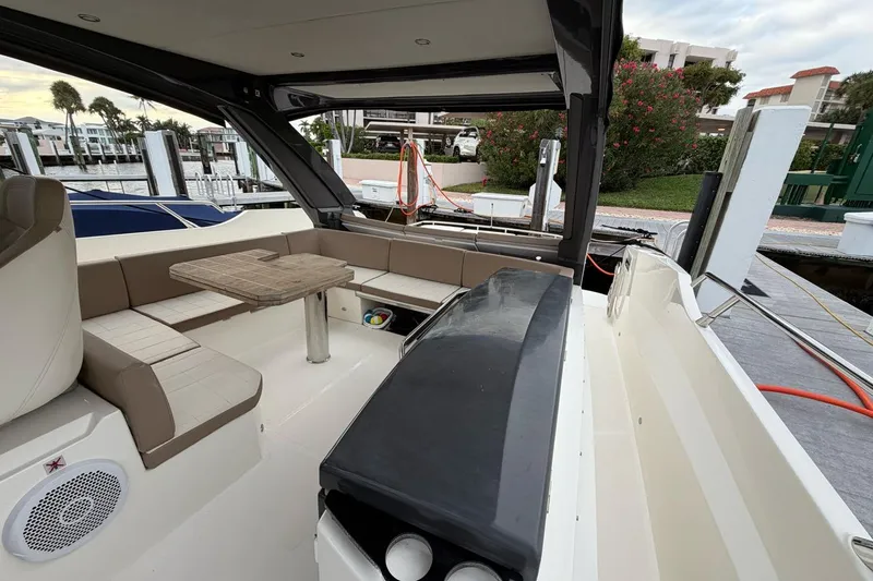  Yacht Photos Pics Luxurious 2019 Absolute 40 SLT yacht interior with seating and table at dock.