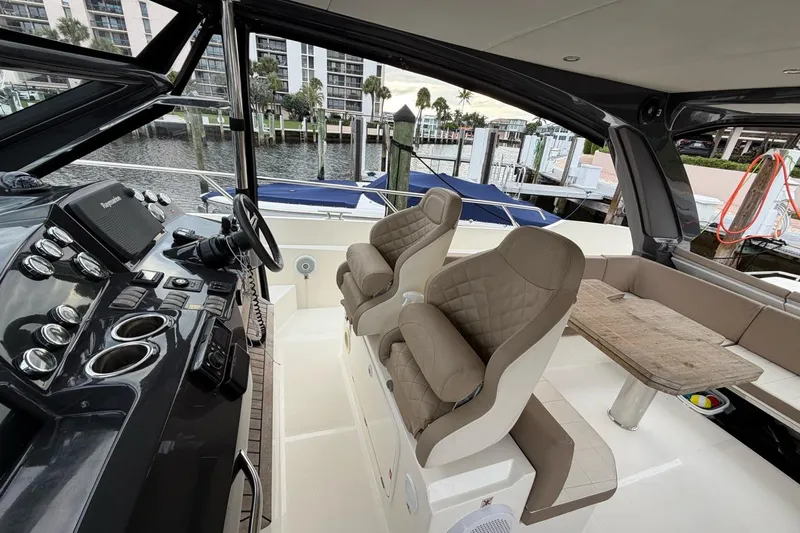  Yacht Photos Pics Interior of 2019 Absolute 40 SLT yacht with helm, seating, and table.