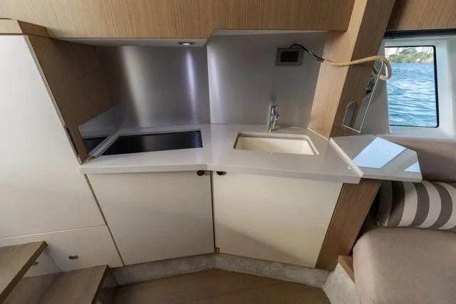 Yacht Photos Pics Compact kitchen area in 2019 Absolute 40 SLT yacht with modern sink and window view.