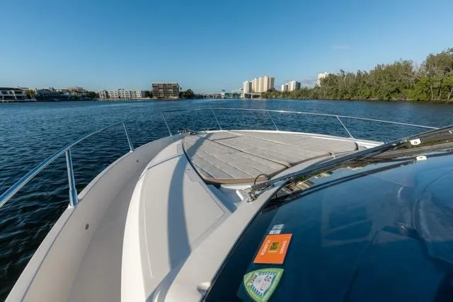  Yacht Photos Pics 2019 Absolute 40 SLT yacht cruising on a calm river with cityscape views.