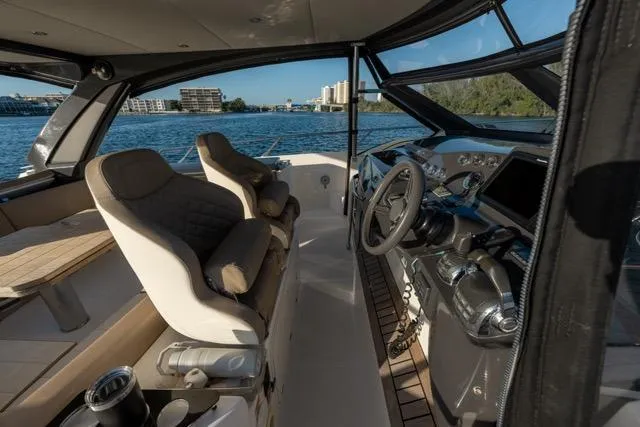  Yacht Photos Pics Luxurious 2019 Absolute 40 SLT yacht interior with modern helm and seating, overlooking serene waters.