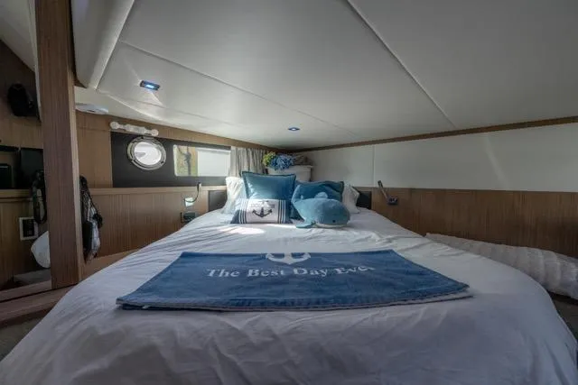  Yacht Photos Pics Luxurious cabin interior of 2019 Absolute 40 SLT yacht with cozy bedding and decor.